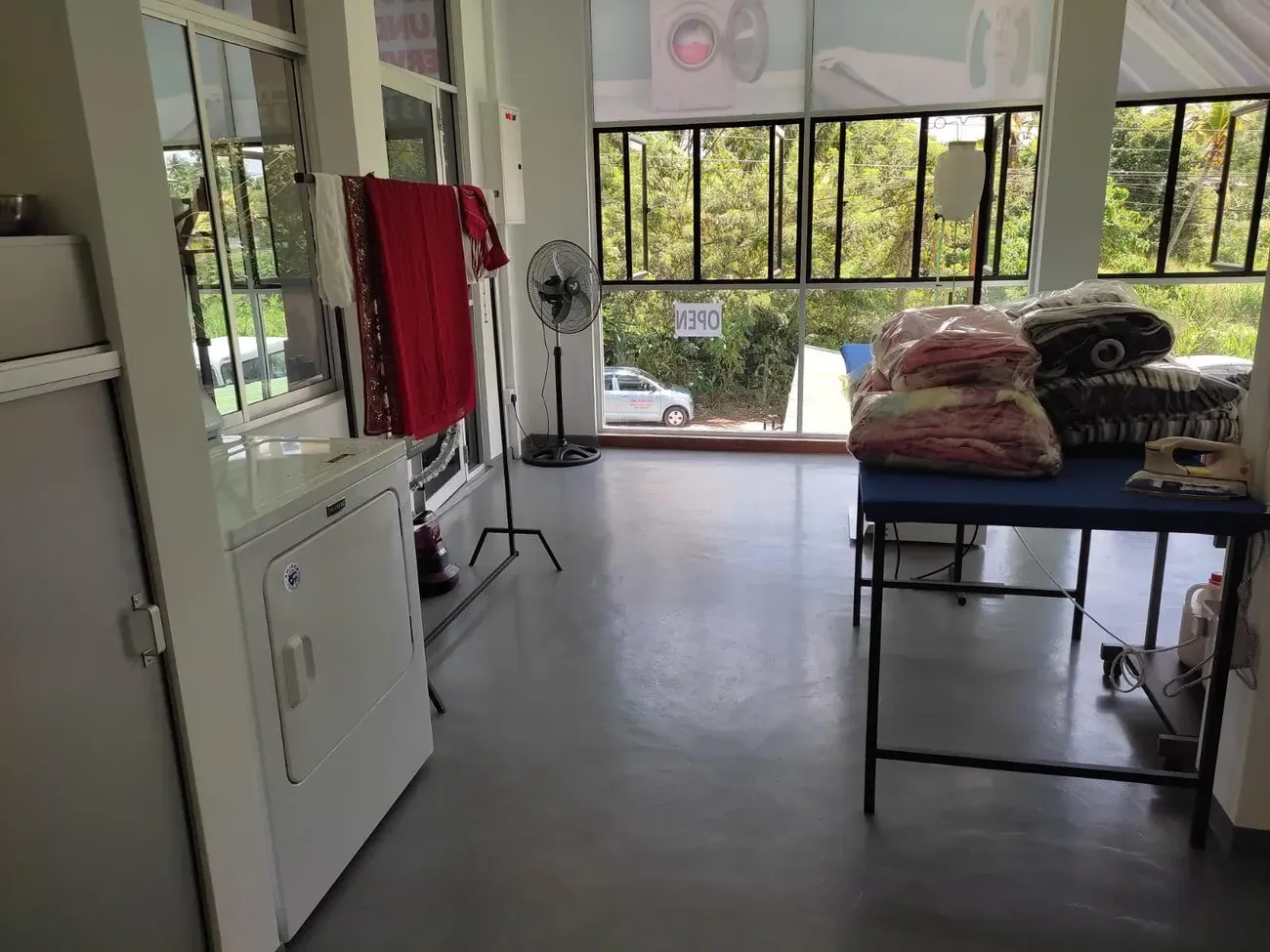 The drying and finishing area with freshly cleaned linens at Champion Laundry, Gampaha