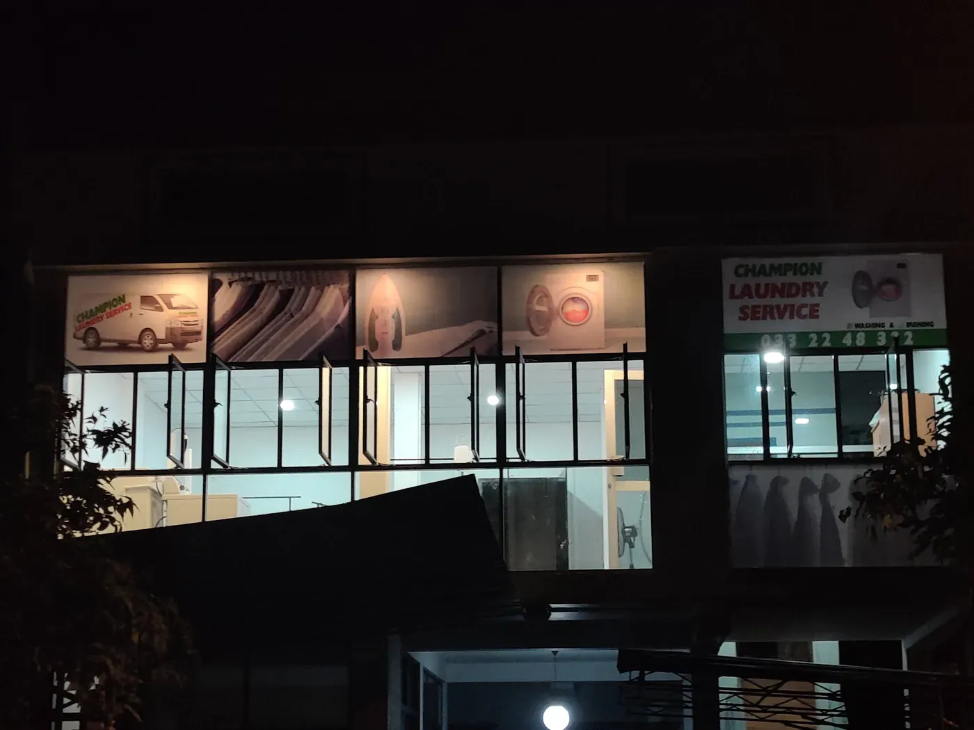 Champion Laundry shopfront lit up in the evening in Gampaha